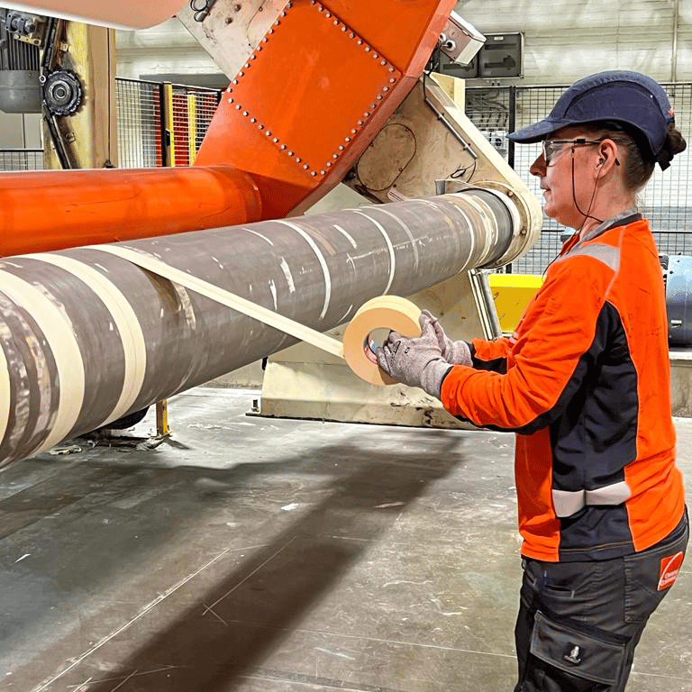 Vrouwelijke operator aan het werk in de papierindustrie